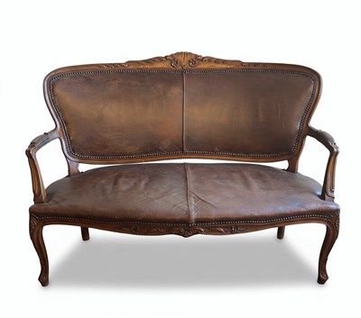 Lot 97 - A 20TH CENTURY ROCOCO REVIVAL SETTEE OR BANQUETTE
Carved dark wood frame with distressed leather upholstery and brass studding.