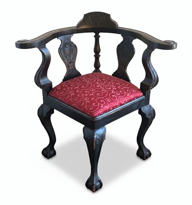 Lot 175 - A 20TH CENTURY ENGLISH QUEEN ANNE REVIVAL CORNER CHAIR
Carved dark wood with textile upholstery