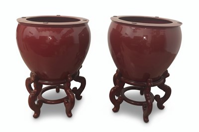 Lot 187 - A Pair of 20th-Century Chinese 'Sang de Boeuf' Glazed Porcelain Jardinières with Stands