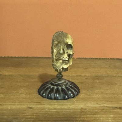 Lot 35 - A carvec bone double-side "memento mori" head
