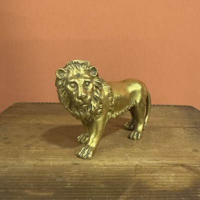 Lot 39 - A parcel-gilt and chased bronze figure of a lion