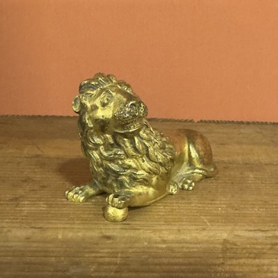 Lot 33 - A chased and gilt-bronze figure of a recumbent lion