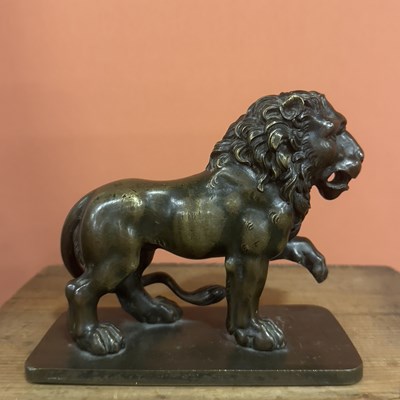Lot 42 - A cast patinated bronze figure of a lion