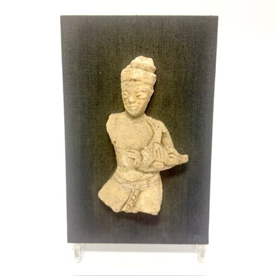 Lot 97 - An antique Siamese stucco fragment of a figure holding a hamsa