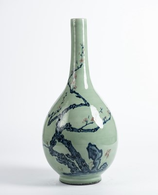 Lot 154 - A CELADON-GROUND UNDERGLAZE-BLUE AND COPPER-RED 'PRUNUS' BOTTLE VASE