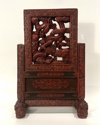 Lot 125 - A rare imperial carved three-color cinnabar carved lacquer "dragon" table screen